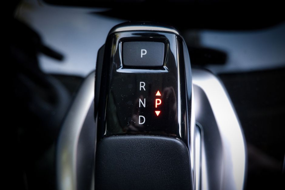 Detailed view of a modern automatic car gear shifter displaying P, R, N, D settings.